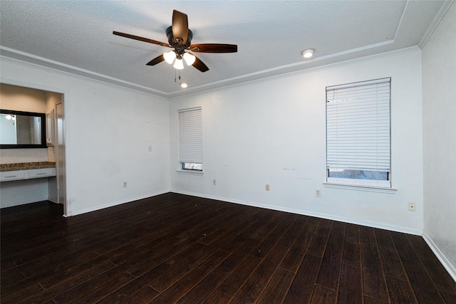 empty room with a textured ceiling, ceiling fan, crown molding, and dark hardwood / wood-style flooring