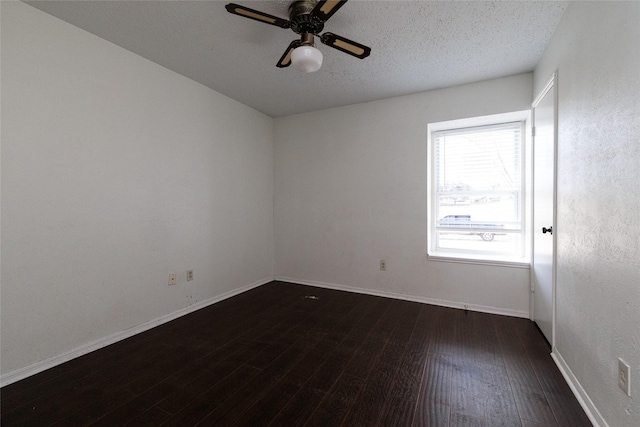 unfurnished room with a textured ceiling, ceiling fan, and dark hardwood / wood-style flooring