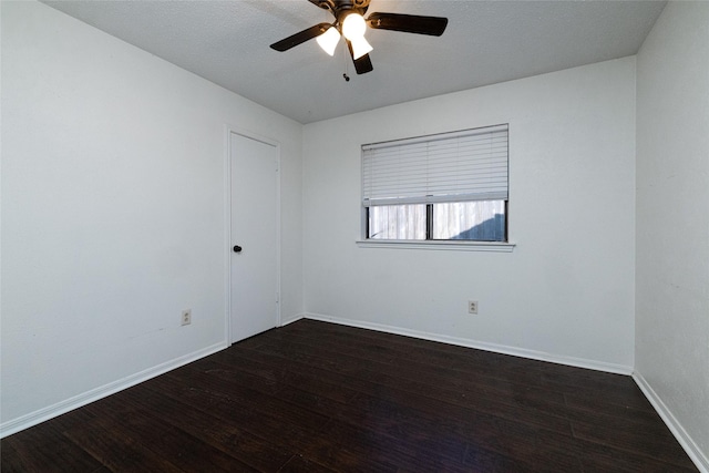 unfurnished room with ceiling fan and dark hardwood / wood-style flooring