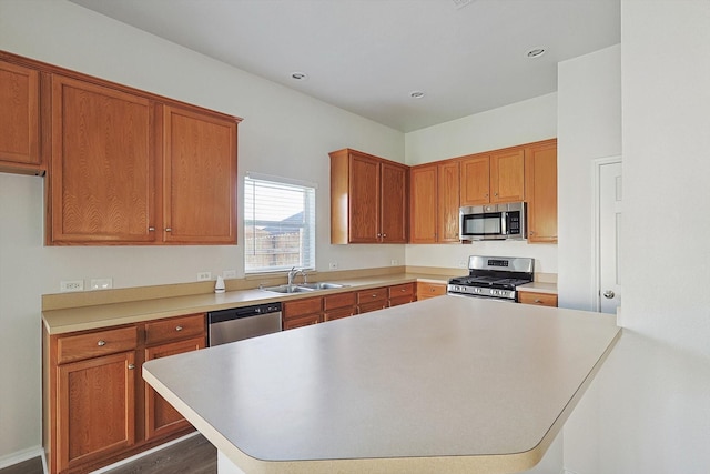 kitchen featuring appliances with stainless steel finishes, dark wood-type flooring, and sink