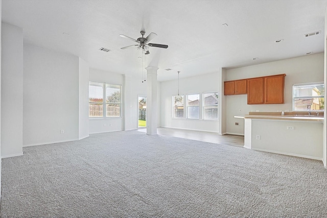 unfurnished living room with carpet floors and ceiling fan