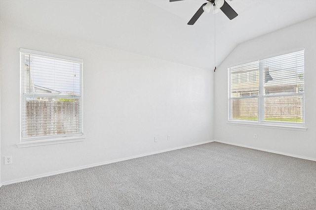 carpeted spare room with ceiling fan and vaulted ceiling