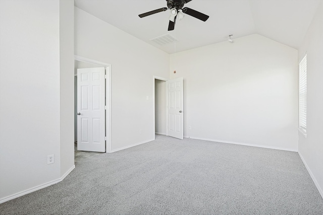 carpeted empty room with ceiling fan and lofted ceiling