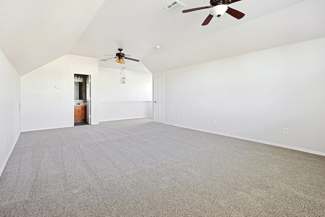 interior space with lofted ceiling, ceiling fan, and carpet flooring