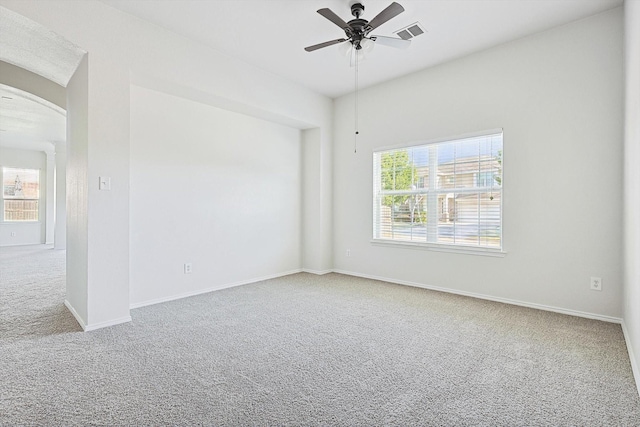 carpeted spare room with ceiling fan