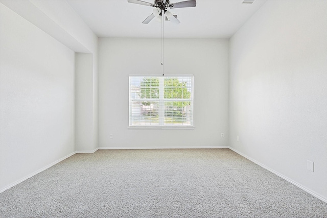 spare room with ceiling fan and carpet