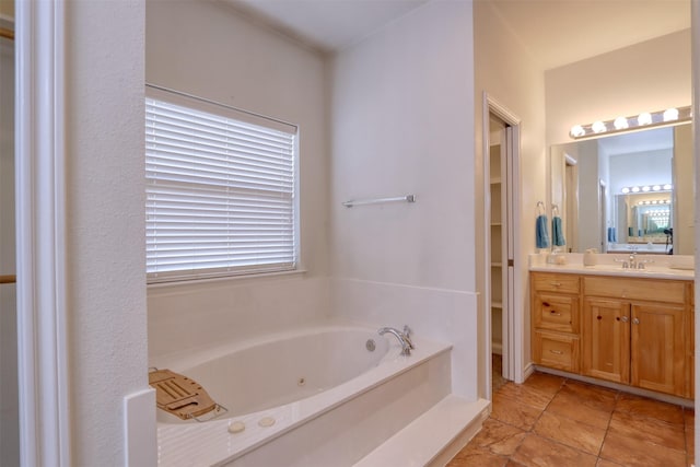 bathroom with vanity and a tub