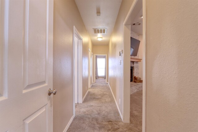 corridor with light colored carpet