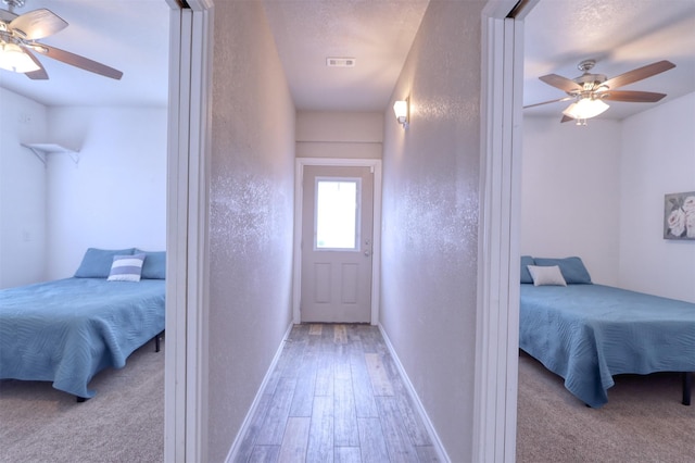 bedroom with light wood-type flooring and ceiling fan