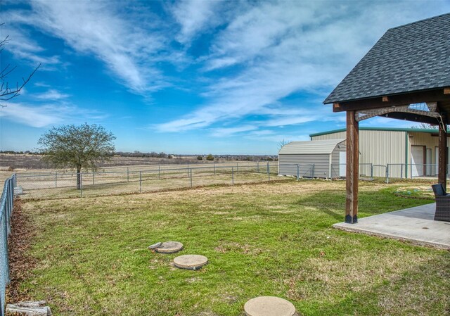 view of yard featuring a patio area and a rural view