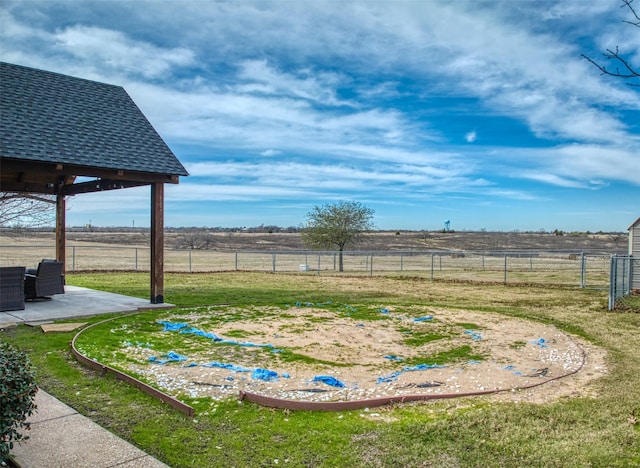 view of yard with a patio area and a rural view