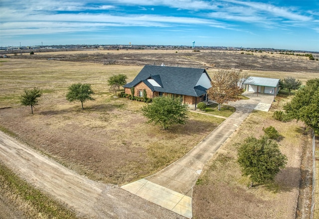 birds eye view of property with a rural view