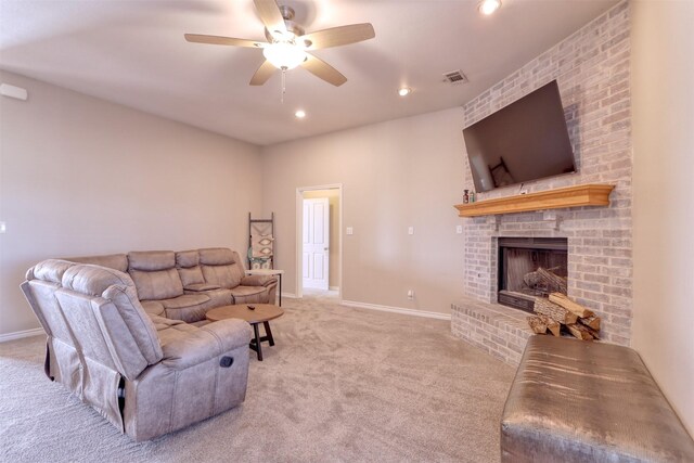 carpeted living room featuring ceiling fan and a brick fireplace