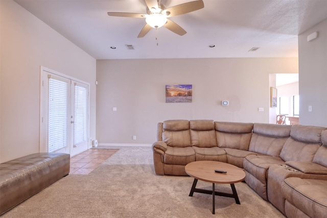 carpeted living room featuring french doors and ceiling fan