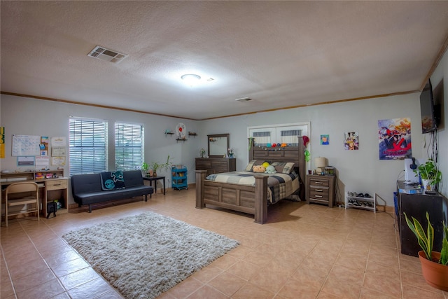 bedroom with a textured ceiling, ornamental molding, and light tile patterned floors