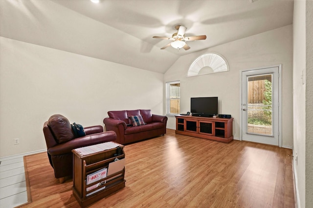 living room featuring lofted ceiling, light wood-type flooring, and ceiling fan