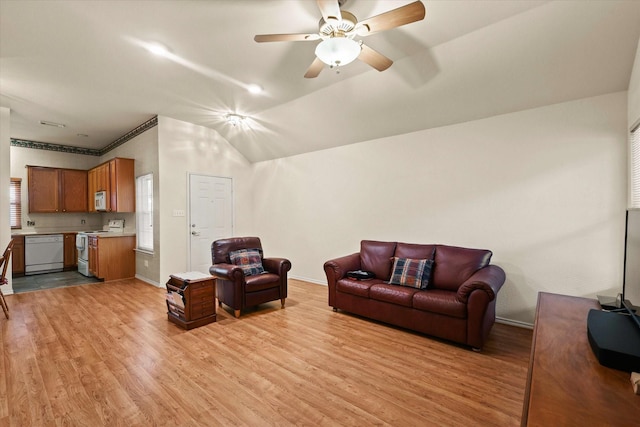 living room featuring light wood-type flooring, ceiling fan, and vaulted ceiling