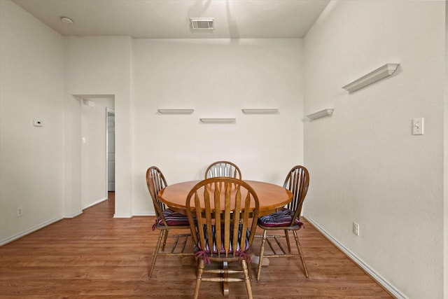 dining area with dark wood-type flooring