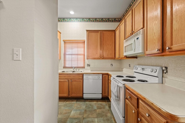 kitchen featuring white appliances and sink