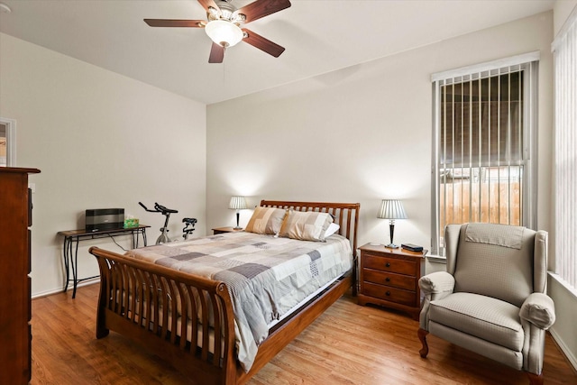 bedroom with ceiling fan and light hardwood / wood-style flooring