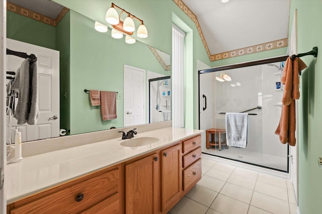 bathroom featuring vanity, tile patterned floors, vaulted ceiling, and a shower with shower door