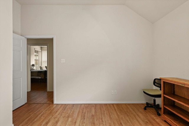 office space featuring light hardwood / wood-style floors and lofted ceiling