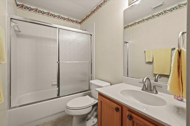 full bathroom featuring bath / shower combo with glass door, vanity, and toilet