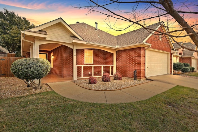 ranch-style home with an attached garage, covered porch, brick siding, and a shingled roof