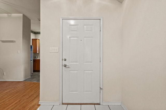 foyer featuring light tile patterned flooring