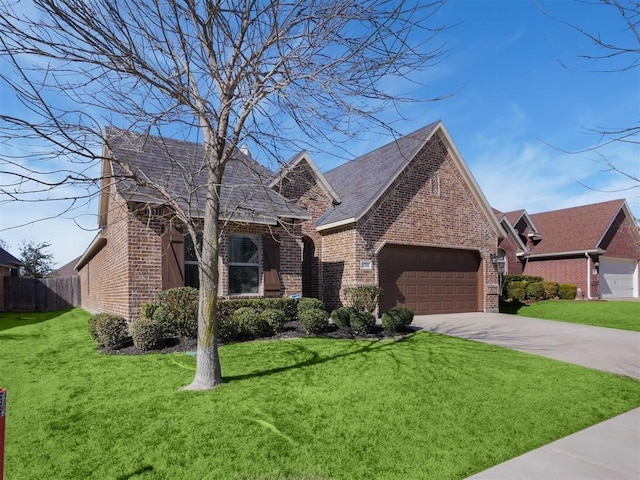 view of front of property with brick siding, a front lawn, and an attached garage