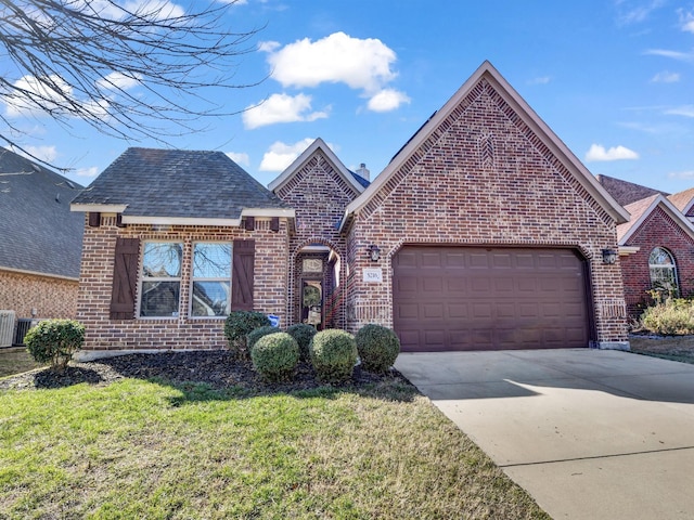 view of front of home with a garage and a front lawn