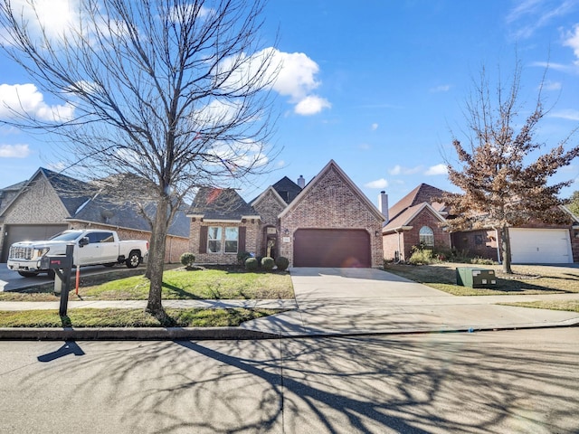 view of front of house featuring driveway, brick siding, and an attached garage