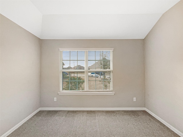 unfurnished room with carpet floors and lofted ceiling