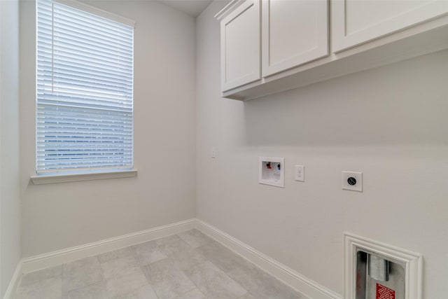 clothes washing area with cabinets, hookup for a washing machine, a wealth of natural light, and hookup for an electric dryer