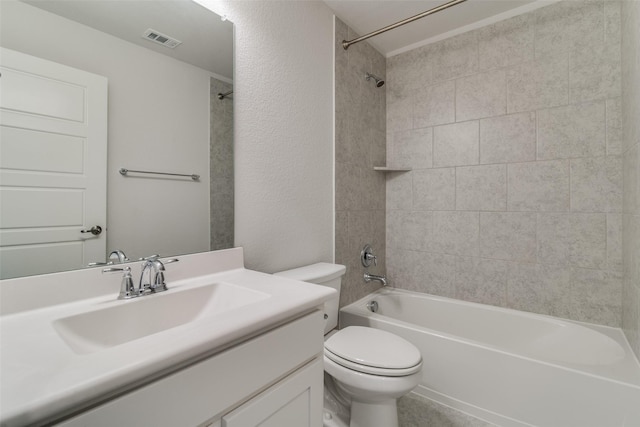 full bathroom with toilet, vanity, and tiled shower / bath