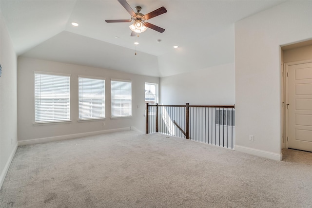 unfurnished room featuring lofted ceiling, ceiling fan, and a healthy amount of sunlight