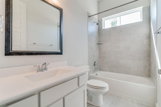 full bathroom with toilet, vanity, tile patterned floors, and tiled shower / bath