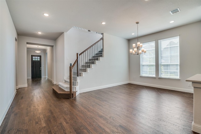 foyer featuring an inviting chandelier and dark wood-type flooring