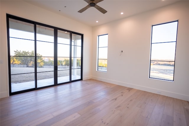 spare room featuring ceiling fan and light hardwood / wood-style flooring