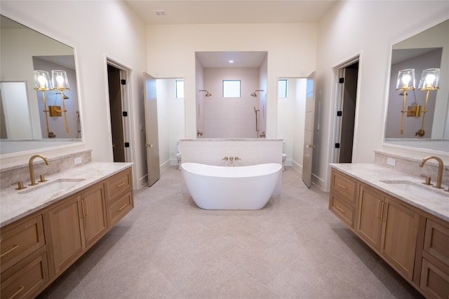 bathroom featuring an inviting chandelier, shower with separate bathtub, and vanity