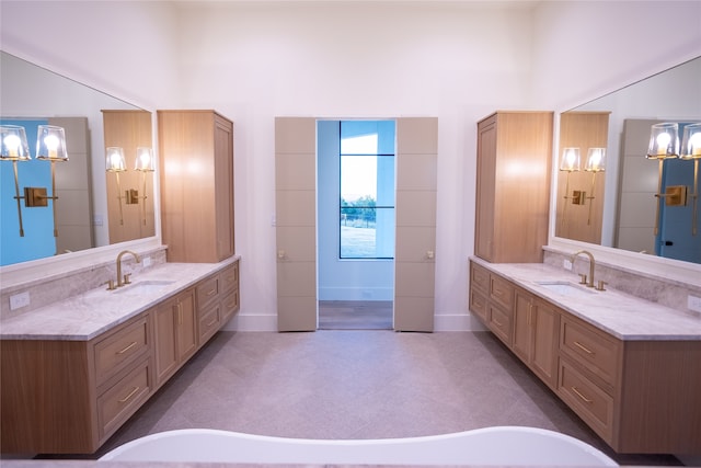 bathroom featuring a towering ceiling and vanity