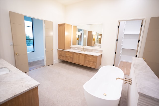 bathroom with vanity and a tub