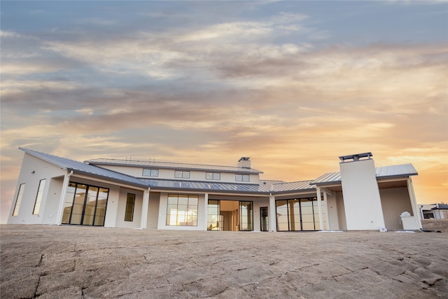 view of back house at dusk