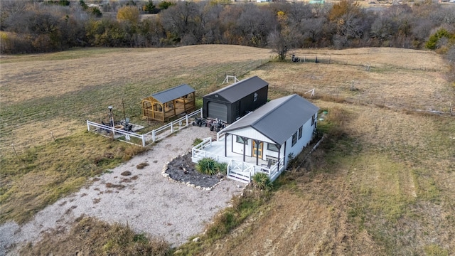 birds eye view of property with a rural view