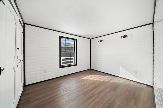 unfurnished room with dark wood-type flooring