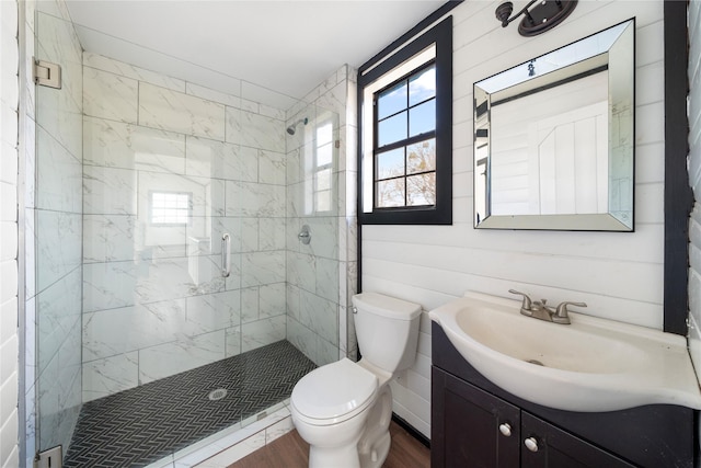 bathroom with toilet, wood-type flooring, vanity, and walk in shower