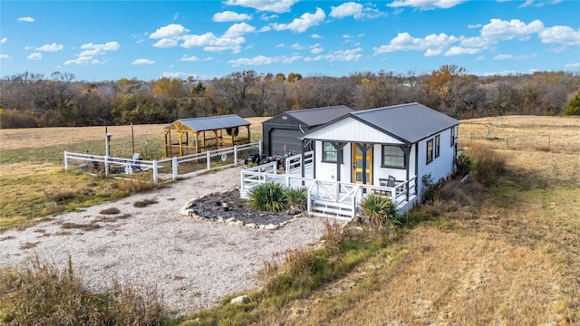 view of front of property featuring an outbuilding and a rural view