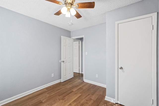 unfurnished bedroom featuring a textured ceiling, ceiling fan, and wood-type flooring