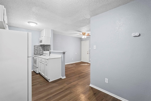 kitchen with white appliances, dark hardwood / wood-style flooring, a textured ceiling, white cabinetry, and backsplash