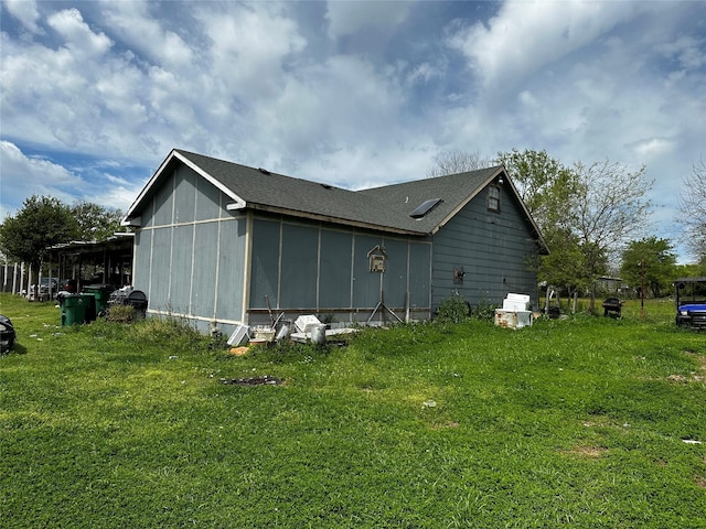 view of side of property with a yard and a carport